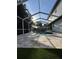 Gorgeous outdoor pool area under a screened enclosure, surrounded by stone patio at 9067 Cypress Trl, Seminole, FL 33777