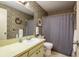 A bathroom with patterned walls, a vanity with a sink, and a shower with a curtain at 908 Highview Dr, Palm Harbor, FL 34683