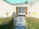 Inviting front entrance with decorative stepping stones, vibrant bushes, and unique lamps at 9331 Mark Twain Ln, Port Richey, FL 34668