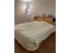 Serene bedroom with a plush bed, built-in headboard storage, and warm, inviting lighting at 10002 Daffodil N St # 51, Pinellas Park, FL 33782