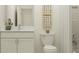 Modern bathroom features white cabinetry, a white countertop, framed art, and a shower with subway tile at 11563 71St E Ave, Palmetto, FL 34221