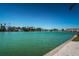 Breathtaking waterfront view showcasing the calm waters, residential neighborhood, and tropical foliage at 12100 Capri S Cir # 203, Treasure Island, FL 33706