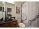 Bathroom featuring dark vanity, unique basin, and a marble design shower curtain at 12339 Silton Peace Dr, Riverview, FL 33579