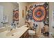 Bathroom showcasing a vanity, mirror, toilet, and decorative patterned shower curtain at 12339 Silton Peace Dr, Riverview, FL 33579