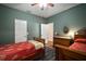 Cozy bedroom showcasing hardwood floors, blue area rug, two twin beds, and matching dresser at 12339 Silton Peace Dr, Riverview, FL 33579