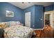 Bright bedroom features hardwood floors, a window with a shutter, and an en-suite bathroom at 12339 Silton Peace Dr, Riverview, FL 33579