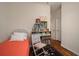 Bright bedroom with hardwood floors, a single bed, and decorative shelving and accents at 12339 Silton Peace Dr, Riverview, FL 33579
