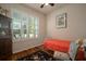 Bedroom featuring shuttered window, single bed, hardwood floor, and colorful decorative accents at 12339 Silton Peace Dr, Riverview, FL 33579