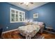 Comfortable bedroom with hardwood floors, a large window, and a cozy sitting area at 12339 Silton Peace Dr, Riverview, FL 33579