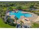 Aerial view of large clover shaped community pool and recreation area with mature landscaping at 12339 Silton Peace Dr, Riverview, FL 33579