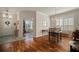 Inviting dining area showcasing hardwood floors, dining table set, and large shuttered windows at 12339 Silton Peace Dr, Riverview, FL 33579