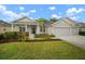 Beautiful single-story home with a well-maintained lawn, landscaped garden, and a welcoming front porch with decorative columns at 12339 Silton Peace Dr, Riverview, FL 33579