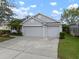 Spacious two-car garage with a wide driveway, complemented by well-maintained landscaping and a neatly trimmed lawn at 12339 Silton Peace Dr, Riverview, FL 33579