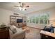 Cozy living room with a large window, plantation shutters, hardwood floors, and comfortable seating at 12339 Silton Peace Dr, Riverview, FL 33579
