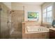 Beautiful main bathroom featuring a soaking tub and separate glass enclosed shower at 12339 Silton Peace Dr, Riverview, FL 33579