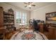 Inviting home office with ample natural light, hardwood floors, and built-in bookshelves at 12339 Silton Peace Dr, Riverview, FL 33579