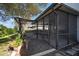 A cozy screened patio offers outdoor seating with a lovely garden view, perfect for relaxing and entertaining at 12339 Silton Peace Dr, Riverview, FL 33579