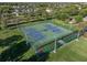 Aerial view of community tennis courts with lush green surroundings, a perfect place to exercise at 12339 Silton Peace Dr, Riverview, FL 33579