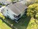 Aerial view of home featuring well-maintained yard, screened lanai and mature trees at 12411 Eagleswood Dr # B, Hudson, FL 34667