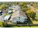 An aerial view of townhomes shows the property's layout, landscaping, and parking, nestled in a green, tree-lined community at 12411 Eagleswood Dr # B, Hudson, FL 34667