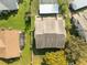 A bird's-eye view of a well-maintained home with a lush, green yard and a detached garage at 12411 Eagleswood Dr # B, Hudson, FL 34667
