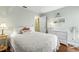 Bright bedroom featuring wood floors, a comfortable bed, and white dresser at 12411 Eagleswood Dr # B, Hudson, FL 34667