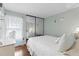 Inviting bedroom with mirrored closet doors, wood floors, and bright, natural light at 12411 Eagleswood Dr # B, Hudson, FL 34667