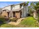 Charming townhome featuring brick accents, neutral siding, landscaped entrance, and well-maintained lawn at 12411 Eagleswood Dr # B, Hudson, FL 34667