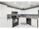 Functional kitchen with white cabinetry, black appliances, and ample countertop space perfect for everyday cooking at 12411 Eagleswood Dr # B, Hudson, FL 34667