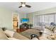 Inviting living room with modern furniture, hardwood floors, patio access, and an open doorway to the bedroom at 12411 Eagleswood Dr # B, Hudson, FL 34667