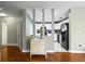 Inviting living area flowing into a modern kitchen, separated by decorative columns and hardwood flooring at 12411 Eagleswood Dr # B, Hudson, FL 34667