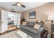 Living room featuring a sofa, ceiling fan, rug, and doorway into the dining area at 12411 Eagleswood Dr # B, Hudson, FL 34667