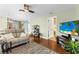 Spacious living room adjacent to the dining area, showcasing hardwood floors and neutral paint at 12411 Eagleswood Dr # B, Hudson, FL 34667