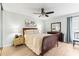 Inviting main bedroom with ceiling fan, a striped bedspread, light-colored wood floors, and lots of natural light at 12411 Eagleswood Dr # B, Hudson, FL 34667