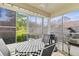 Screened-in patio with a black and white checked table covering and outdoor seating at 12411 Eagleswood Dr # B, Hudson, FL 34667