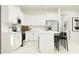 Contemporary kitchen featuring white cabinetry, an island with seating, and stainless steel appliances at 12665 Lily Quartz Loop, Parrish, FL 34219