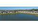 This aerial showcases a tranquil pond and a row of homes in the neighborhood at 12688 Lily Quartz Loop, Parrish, FL 34219