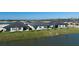 A picturesque backyard view of homes with patios, overlooking a serene pond at 12688 Lily Quartz Loop, Parrish, FL 34219