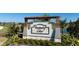 Welcoming entrance to Prosperity Lakes with decorative sign, pergola, and landscaped surroundings at 12688 Lily Quartz Loop, Parrish, FL 34219