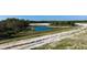 Scenic view of a pond surrounded by green space, offering a tranquil setting at 12688 Lily Quartz Loop, Parrish, FL 34219