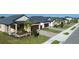 New single-Gathering homes with well-manicured lawns, sidewalks, and attractive curb appeal at 12688 Lily Quartz Loop, Parrish, FL 34219