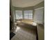 Bathroom with a soaking tub surrounded by multiple windows for natural light at 14116 Trouville Dr, Tampa, FL 33624