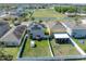Aerial view of a home with solar panels and a fenced backyard cabana in a residential neighborhood at 14422 Scottburgh Glen Dr, Wimauma, FL 33598