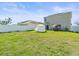 Expansive backyard with a cabana, white fencing, and green grass, perfect for outdoor activities at 14422 Scottburgh Glen Dr, Wimauma, FL 33598