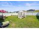 Large, fenced backyard with green lawn and a cabana at 14422 Scottburgh Glen Dr, Wimauma, FL 33598