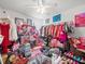 Bright bedroom filled with decor, clothing, shoes, and handbags at 14422 Scottburgh Glen Dr, Wimauma, FL 33598