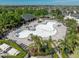 Aerial view of a unique community pool area surrounded by palm trees and lounge chairs at 14422 Scottburgh Glen Dr, Wimauma, FL 33598