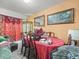Formal dining room with traditional furniture, ornate decor, and plenty of natural light at 14422 Scottburgh Glen Dr, Wimauma, FL 33598