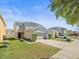 Inviting two-story home with lush green lawn, complemented by a wide driveway at 14422 Scottburgh Glen Dr, Wimauma, FL 33598