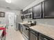 Contemporary kitchen featuring stainless steel appliances and black cabinets at 14422 Scottburgh Glen Dr, Wimauma, FL 33598